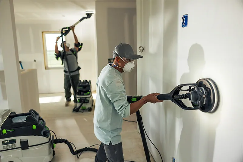 Drywallers using PLANEX drywall sanders