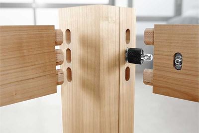 An item of furniture is assembled with dowels