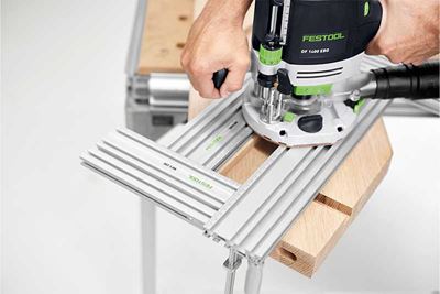 A tradesperson routes a workpiece using several routing templates