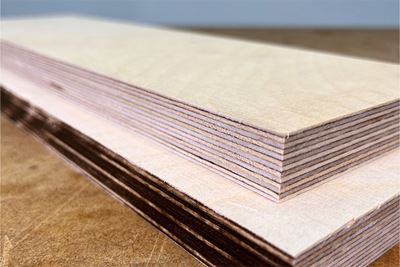 Two cut boards on top of each other, one with a burnt edge