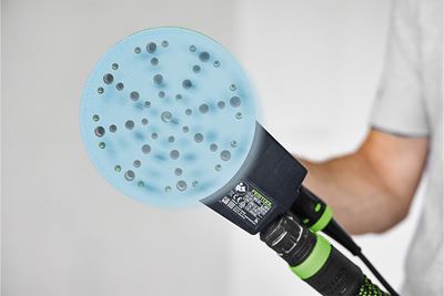 An abrasive moves on an eccentric sander